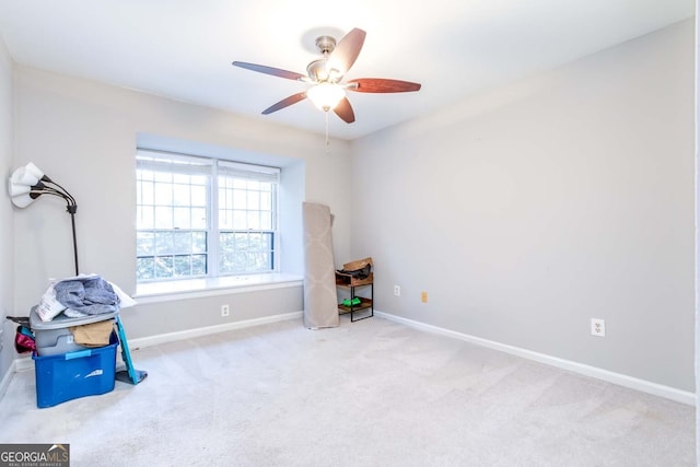 misc room featuring light colored carpet and ceiling fan