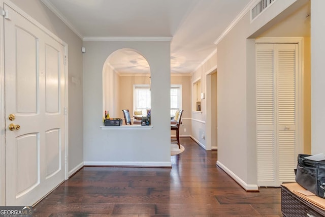 foyer entrance with crown molding and dark hardwood / wood-style floors