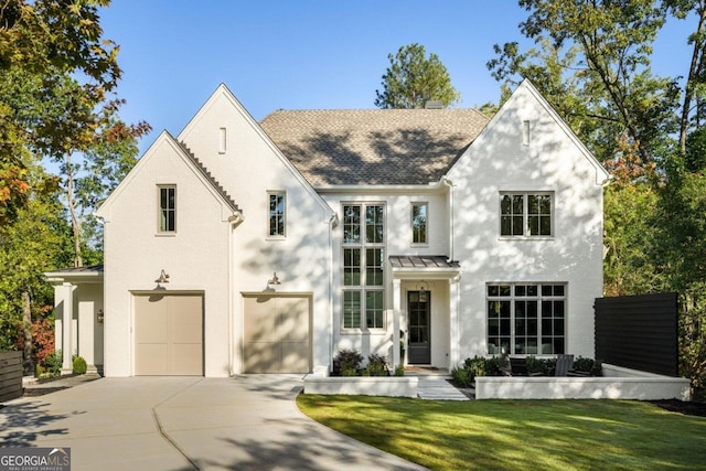 view of front of property featuring a front yard and a garage