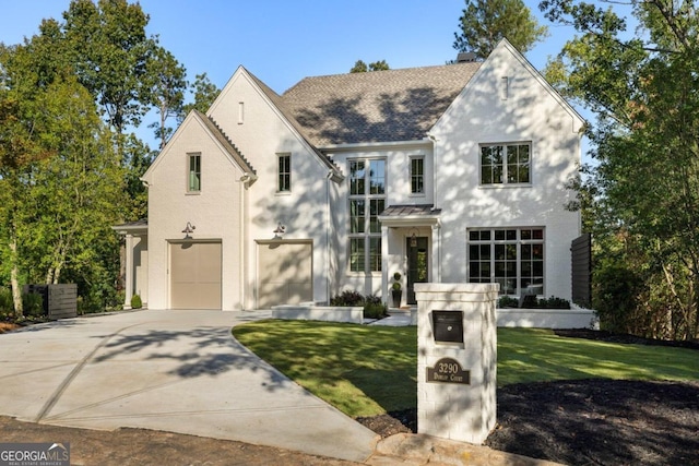 view of front of house with a front yard and a garage