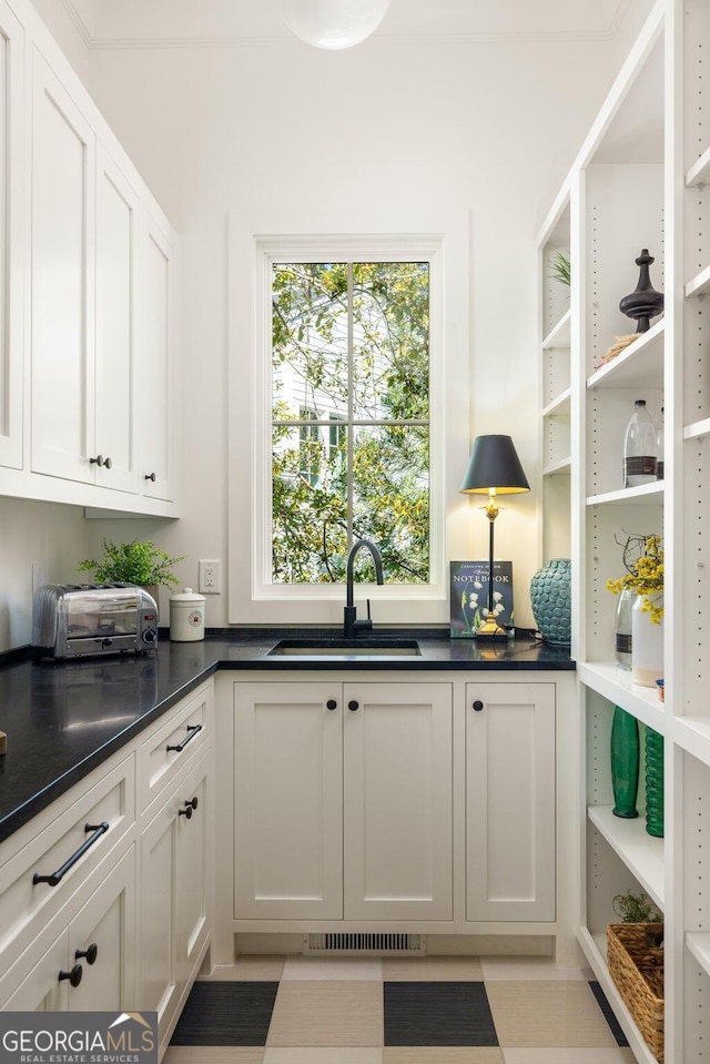 interior space featuring sink and white cabinets