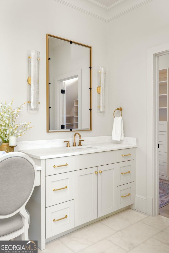 bathroom with ornamental molding and vanity