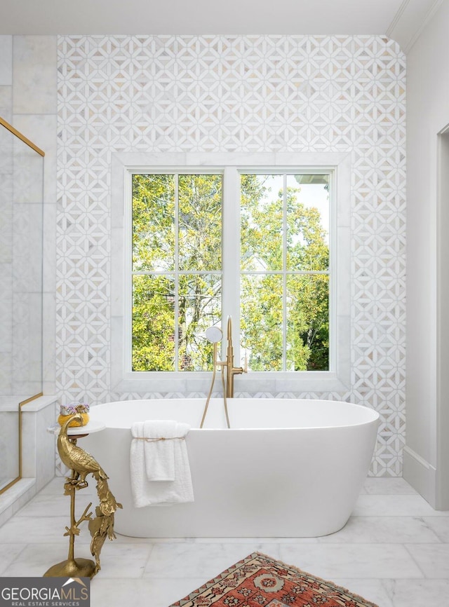 bathroom featuring a tub and a healthy amount of sunlight