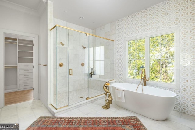 bathroom featuring plus walk in shower and ornamental molding