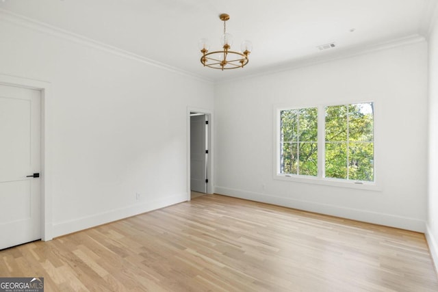 unfurnished room featuring crown molding, light hardwood / wood-style floors, and a notable chandelier