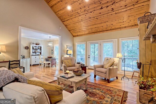 living room with a healthy amount of sunlight, wood ceiling, high vaulted ceiling, and light hardwood / wood-style flooring