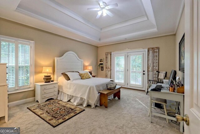 bedroom with light carpet, access to outside, a tray ceiling, and ceiling fan