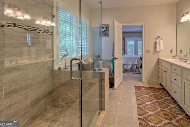 bathroom featuring vanity, walk in shower, and tile patterned flooring