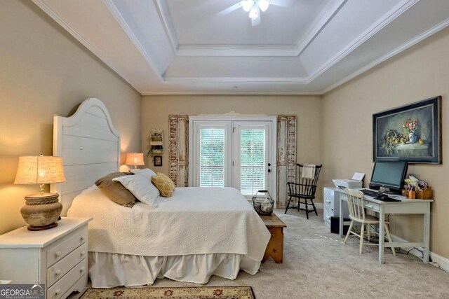 carpeted bedroom with ornamental molding, access to exterior, a tray ceiling, and ceiling fan