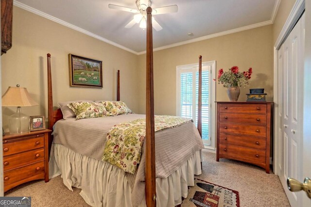 carpeted bedroom with crown molding, a closet, and ceiling fan