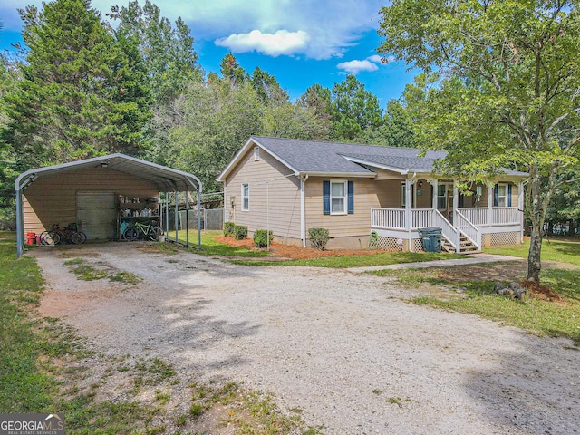 view of front of property featuring covered porch and a carport