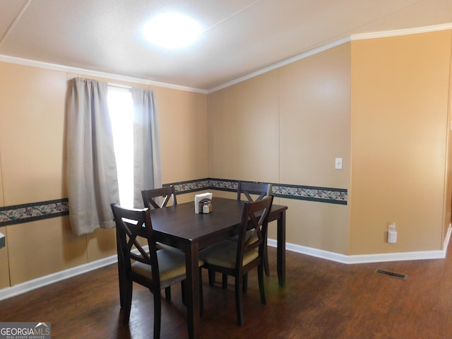 dining area featuring ornamental molding and dark hardwood / wood-style flooring