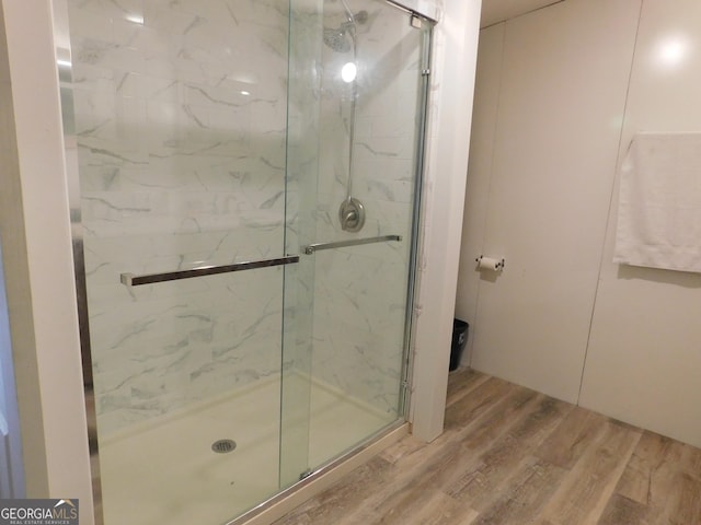 bathroom featuring hardwood / wood-style flooring and an enclosed shower