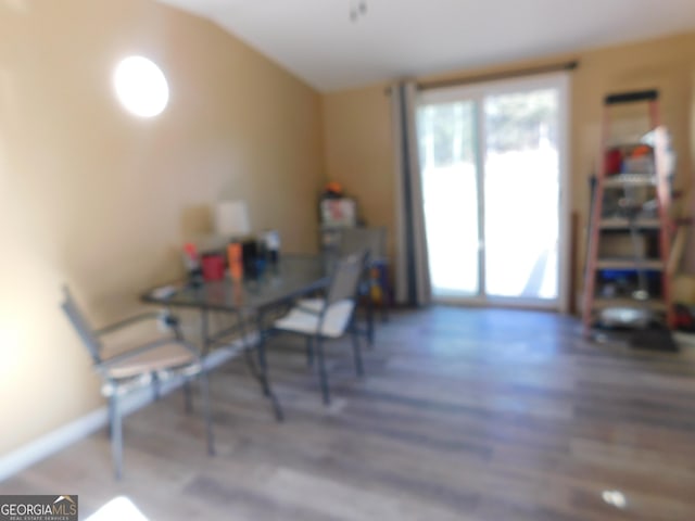 dining area with vaulted ceiling and dark hardwood / wood-style flooring