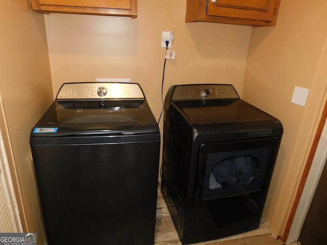 laundry area with cabinets and washer and dryer