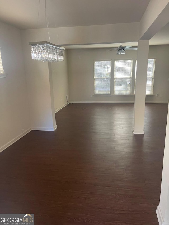 unfurnished room with dark wood-type flooring and ceiling fan