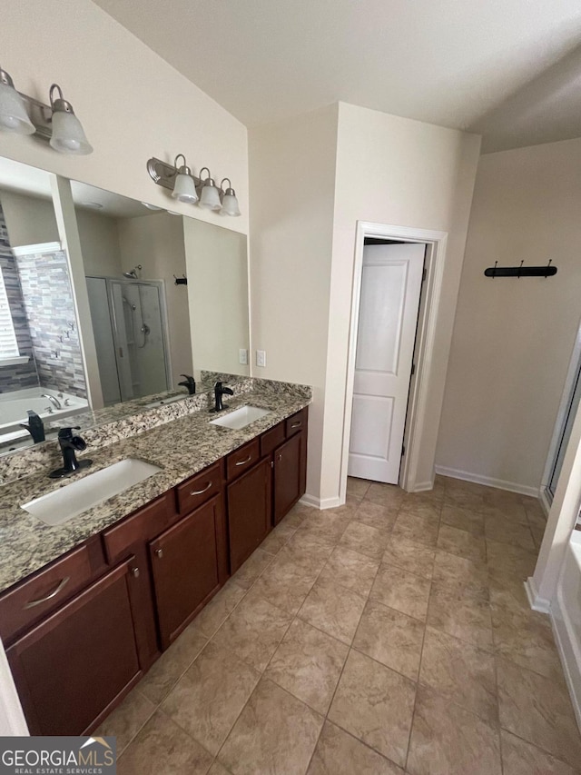 bathroom featuring vanity and independent shower and bath