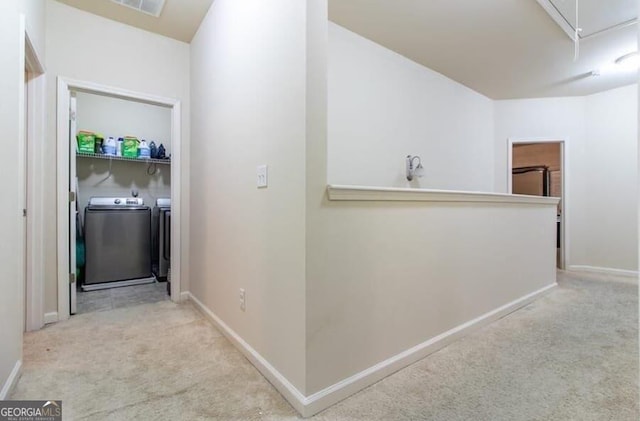 hall featuring light carpet and washing machine and clothes dryer