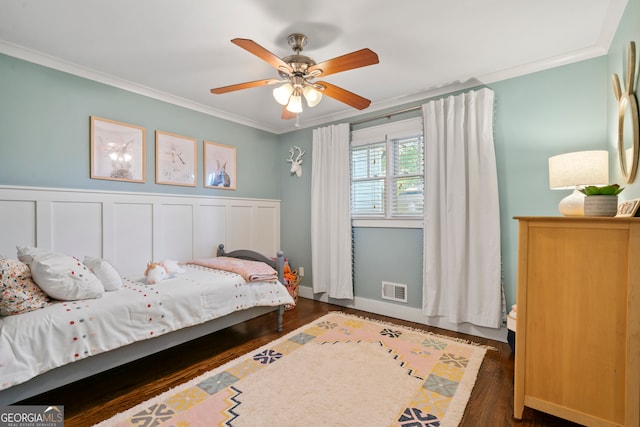 bedroom featuring ceiling fan, dark hardwood / wood-style flooring, and crown molding