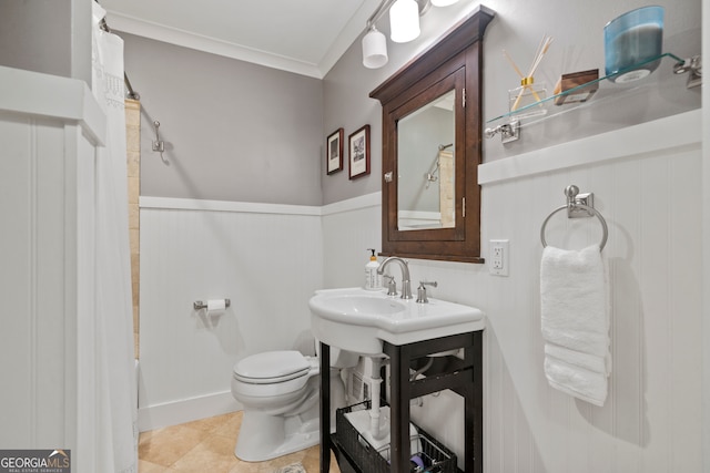 bathroom with tile patterned floors, toilet, crown molding, and shower / tub combo