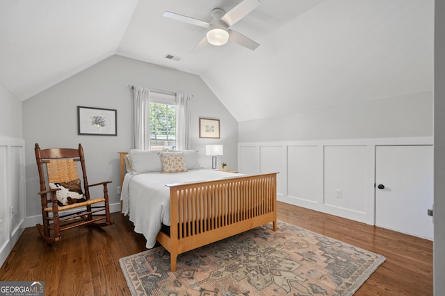 bedroom featuring ceiling fan, dark wood-type flooring, and lofted ceiling