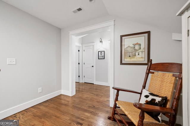 corridor featuring lofted ceiling and dark wood-type flooring