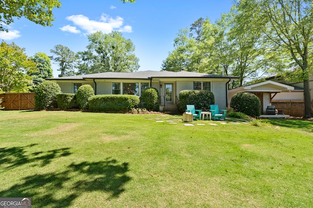 rear view of house with a lawn