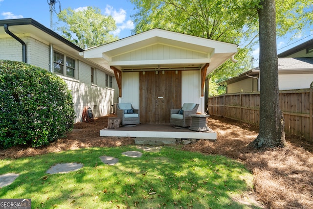 rear view of property with a yard