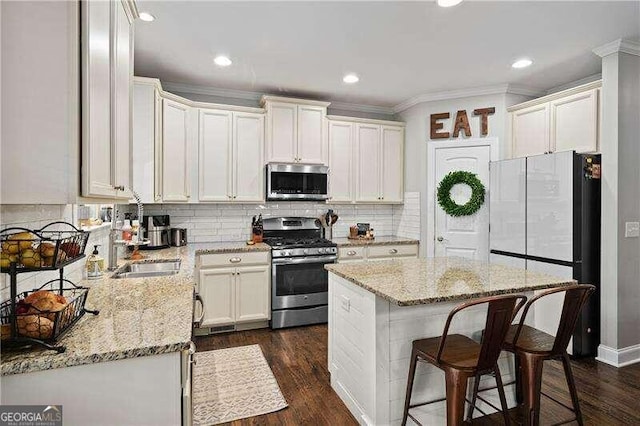 kitchen featuring sink, light stone counters, stainless steel appliances, and dark hardwood / wood-style flooring