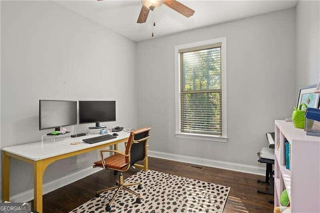 home office with dark hardwood / wood-style floors and ceiling fan