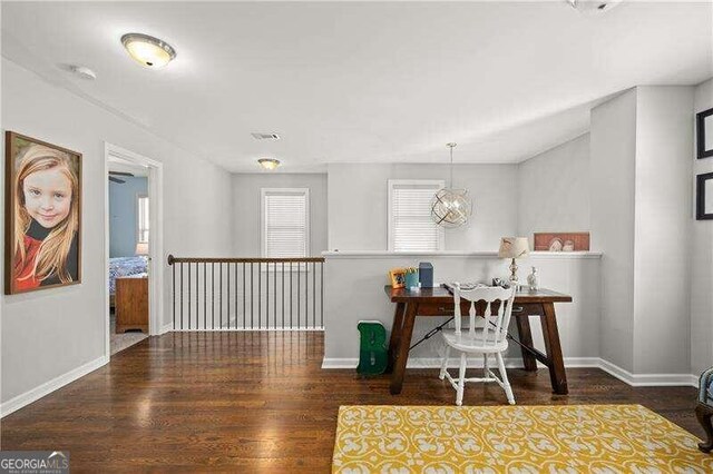 office space with a notable chandelier and dark hardwood / wood-style floors