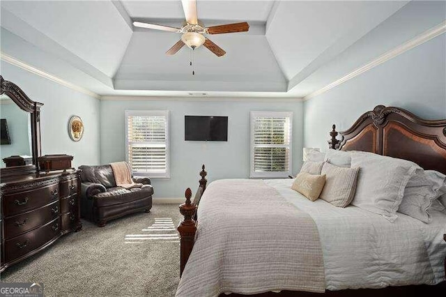 carpeted bedroom featuring multiple windows, ornamental molding, ceiling fan, and a raised ceiling