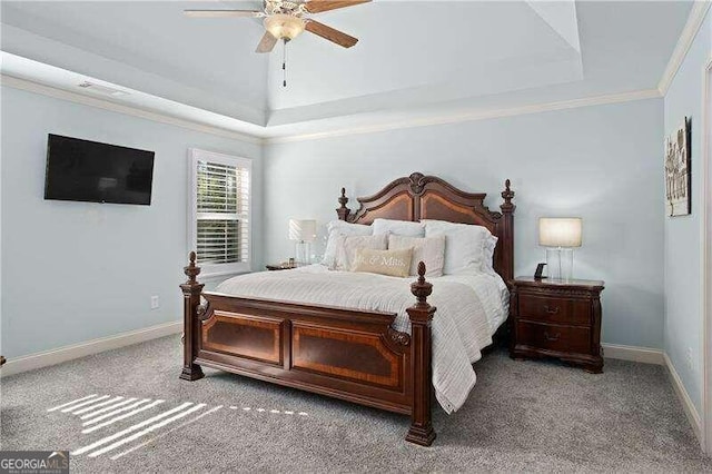 bedroom with ceiling fan, a tray ceiling, carpet flooring, and ornamental molding