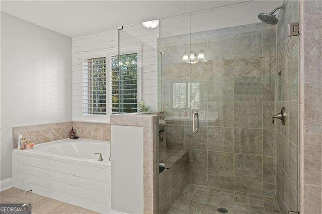 bathroom featuring a chandelier and plus walk in shower