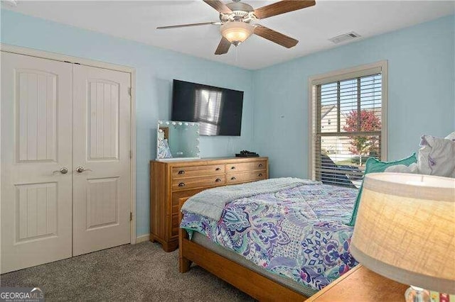 carpeted bedroom with a closet and ceiling fan