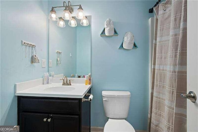 bathroom with vanity, toilet, and a shower with shower curtain