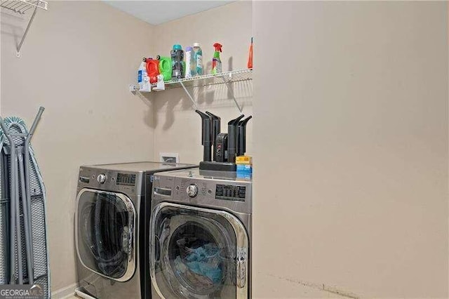 clothes washing area featuring independent washer and dryer