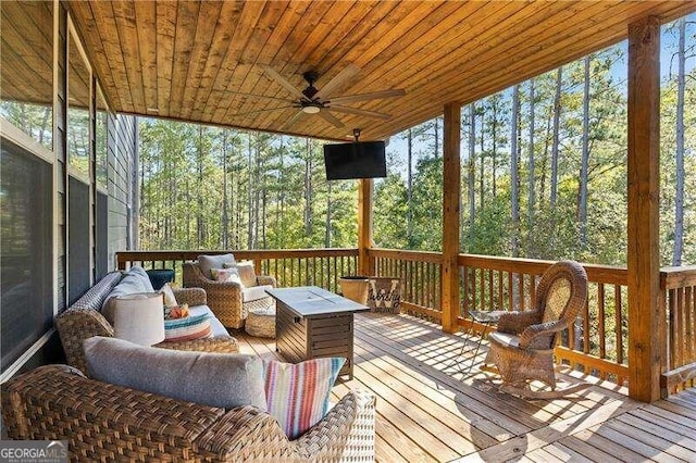 wooden deck featuring an outdoor hangout area and ceiling fan