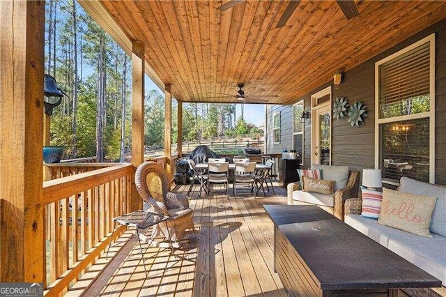 wooden terrace with outdoor lounge area and ceiling fan