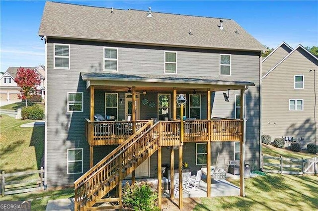 back of property featuring a patio, ceiling fan, and a yard