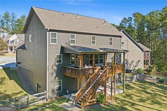 back of house with a yard and a deck