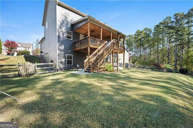 back of property featuring a yard and a deck