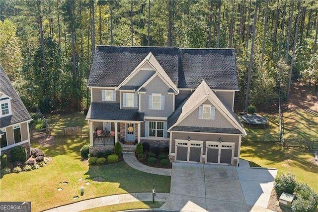 craftsman-style house with a front yard and a garage