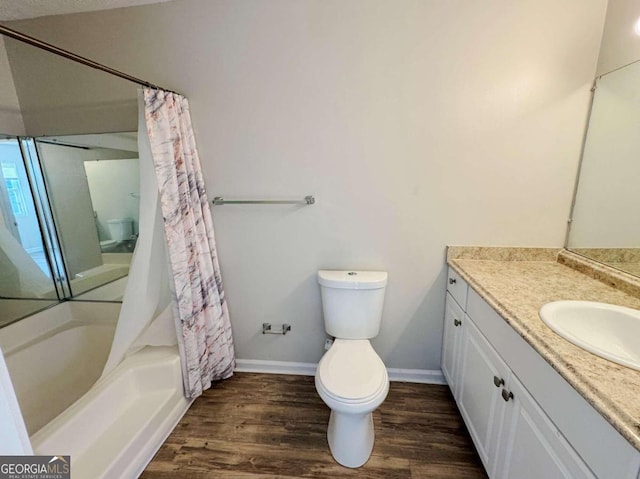 full bathroom with shower / tub combo with curtain, hardwood / wood-style floors, vanity, and toilet