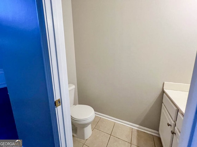 bathroom featuring vanity, tile patterned floors, and toilet