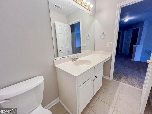 bathroom featuring vanity, toilet, and tile patterned floors