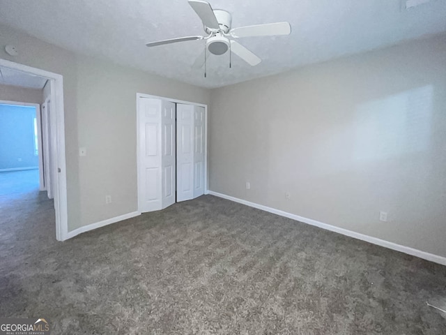 unfurnished bedroom featuring a closet, ceiling fan, and dark carpet