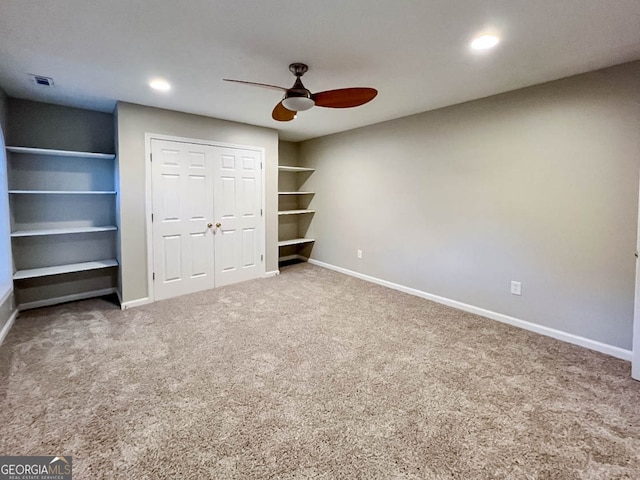 unfurnished bedroom featuring carpet floors, a closet, and ceiling fan