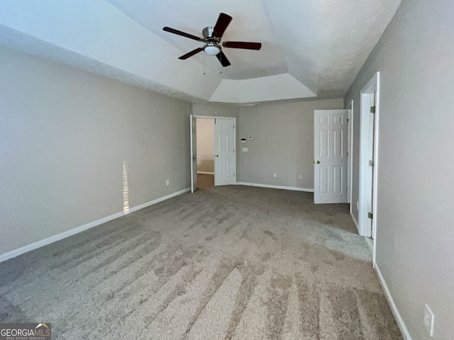 unfurnished bedroom with ceiling fan, light carpet, and vaulted ceiling