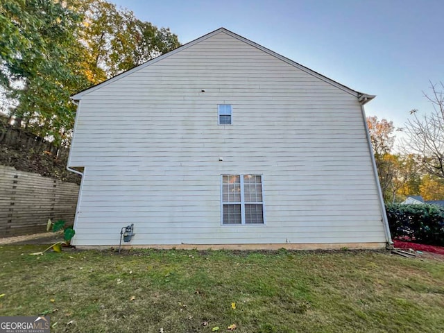 view of side of home featuring a lawn